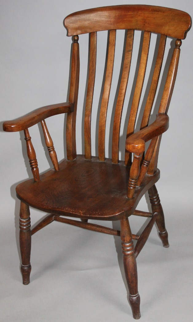 Appraisal: A late thC ash and elm grandfather chair with shaped