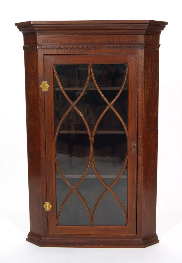 Appraisal: Victorian oak hanging corner cabinet with dentil cornice above a