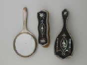 Appraisal: Two silver mounted tortoiseshell brushes and a silver plate mounted