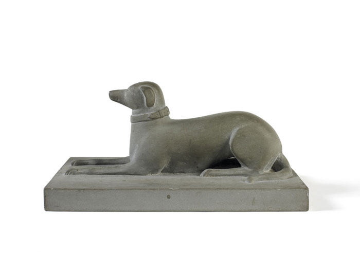 Appraisal: AMERICAN NINETEENTH CENTURY CARVED SLATE RECLINING DOG Height inches Base