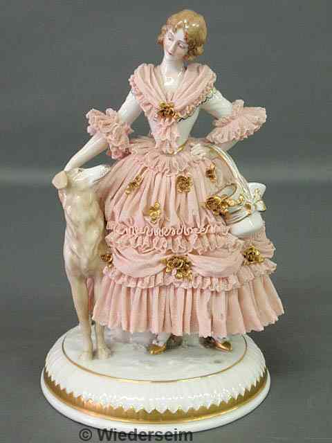 Appraisal: German porcelain figure of a woman and her dog bearing