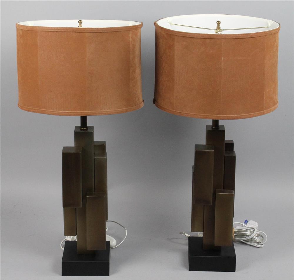 Appraisal: PAIR OF METAL SCULPTURAL BASE TABLE LAMPS with tan shades