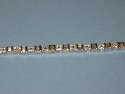 Appraisal: A DIAMOND BRACELET set with baguette and brilliant diamonds on