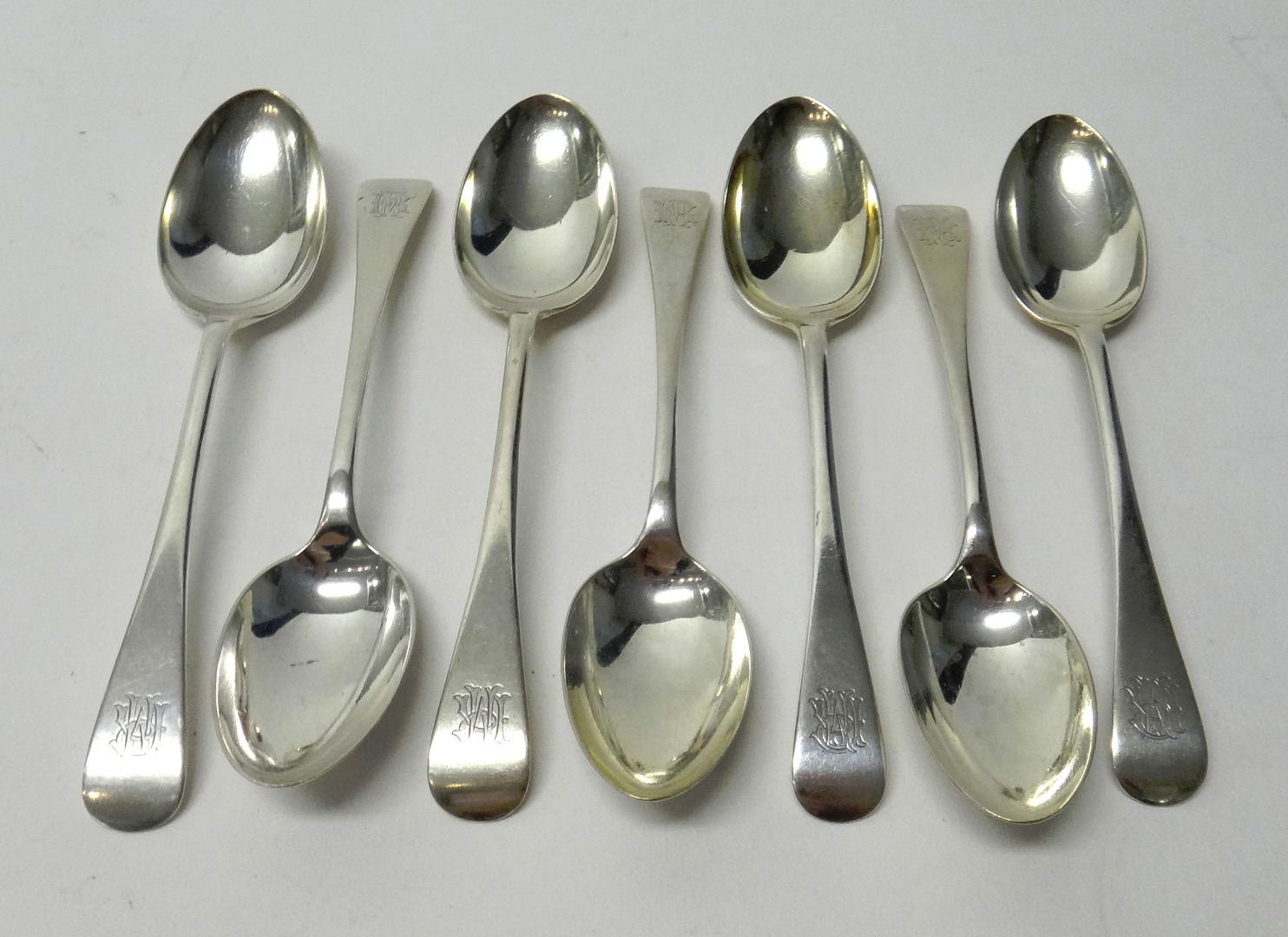 Appraisal: Seven silver Old English pattern dessert spoons all by John