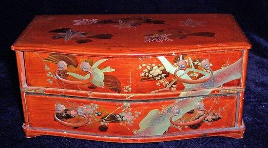 Appraisal: A Japanese red lacquer chest of two drawers and a