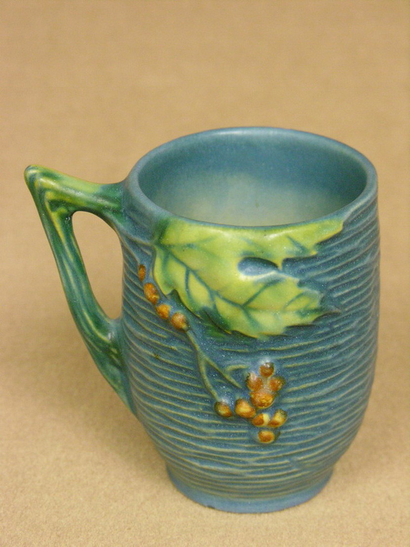 Appraisal: ROSEVILLE BLUE BUSHBERRY MUG Size - Condition Has chip on