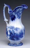 Appraisal: FLOW BLUE PITCHER IN THE SINDE PATTERN Impressed mark Oriental