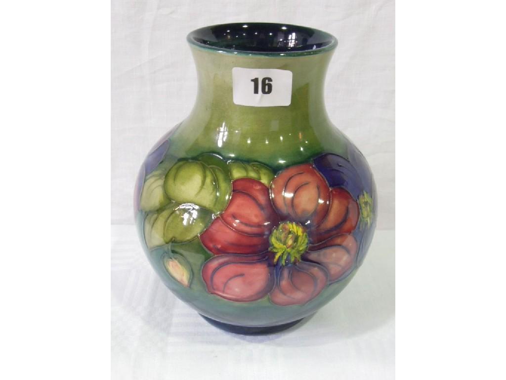 Appraisal: A Moorcroft green ground vase with purple and red anemone