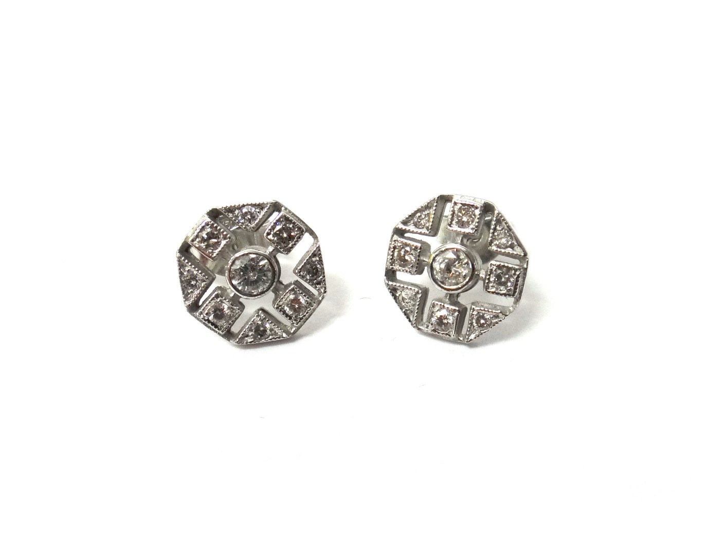 Appraisal: A pair of white gold and diamond set earstuds each