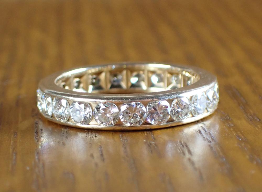 Appraisal: DIAMOND AND FOURTEEN KARAT GOLD ETERNITY RING channel set with