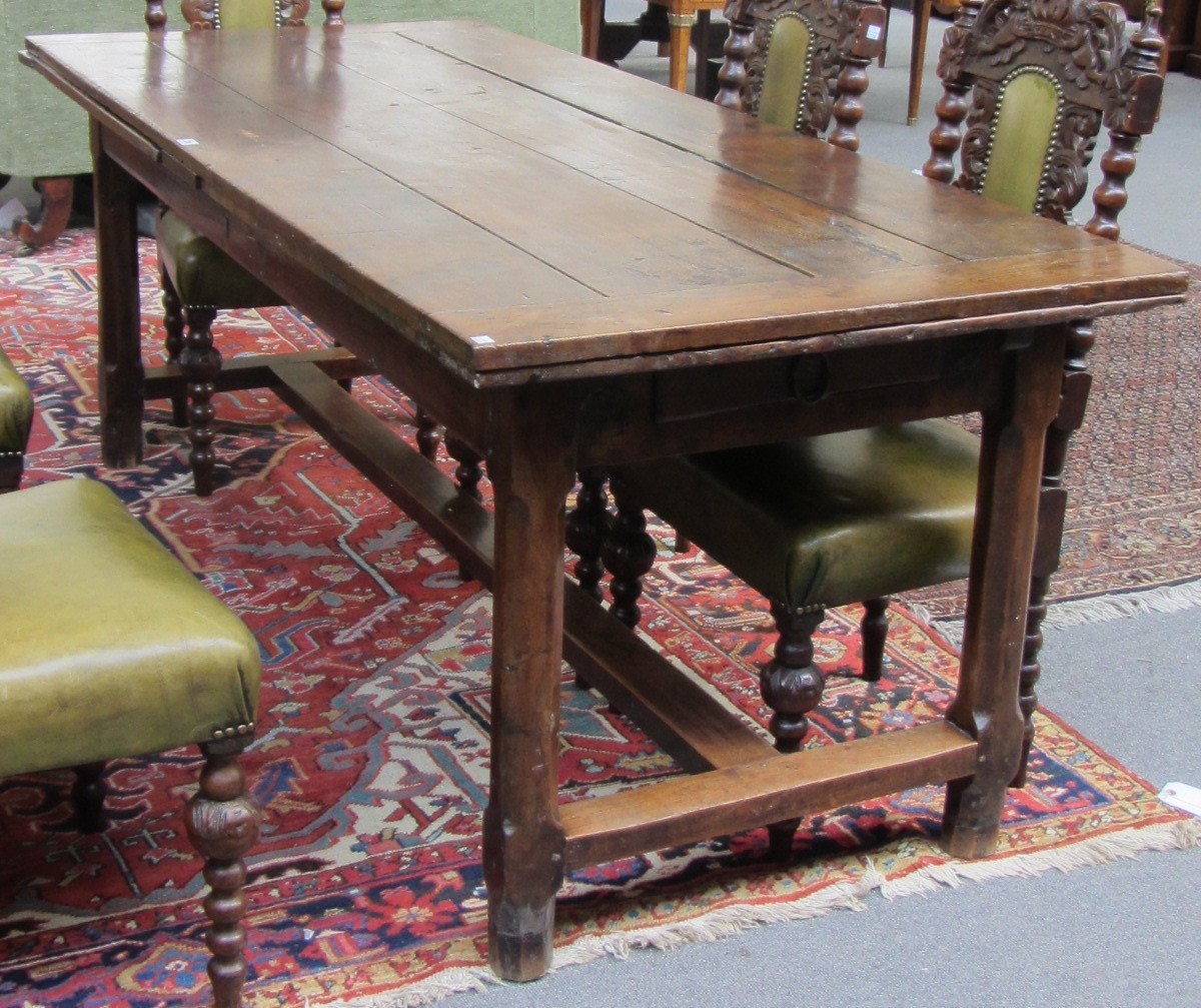 Appraisal: An th century French extending oak dining table the plank