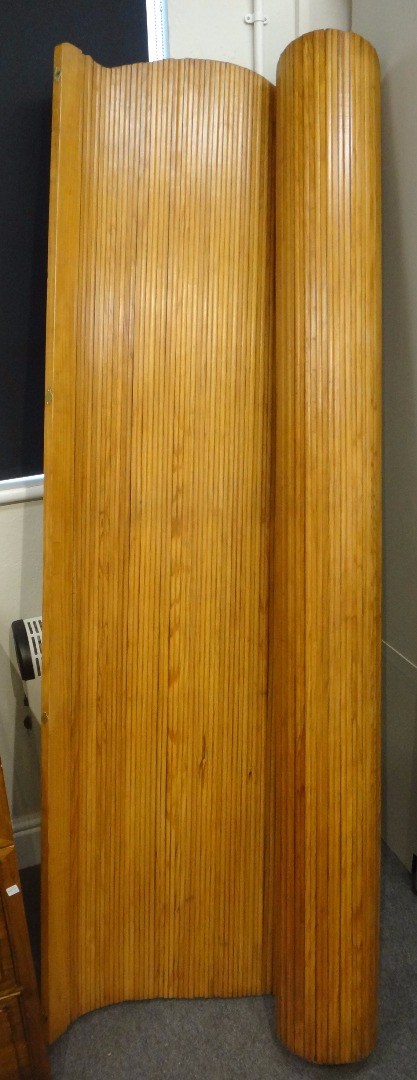 Appraisal: A pine tambour screen room divider with maker's plaque 'S