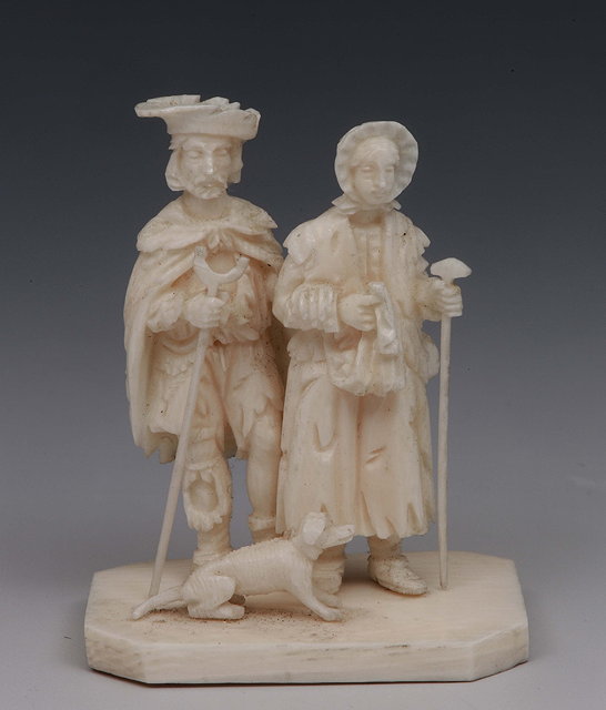 Appraisal: A European miniature ivory group of two figures with a