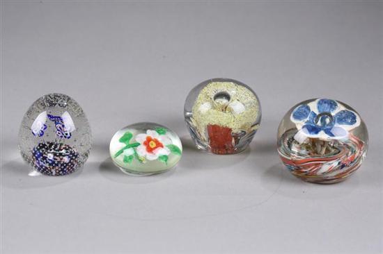 Appraisal: FOUR GLASS PAPERWEIGHTS A single blue flower with multi-colored swirls