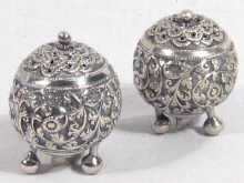 Appraisal: A pair of Indian silver peppers with embossed decoration