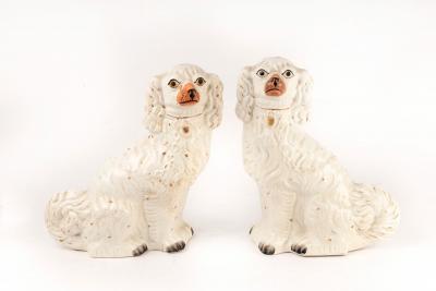 Appraisal: A pair of white glazed Staffordshire dogs cm high