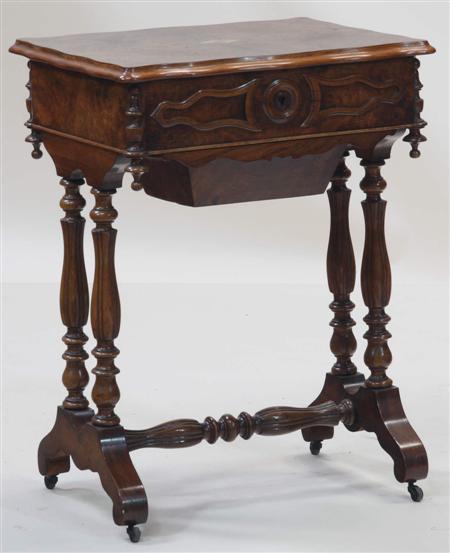 Appraisal: A Victorian walnut work table the serpentine moulded top opening