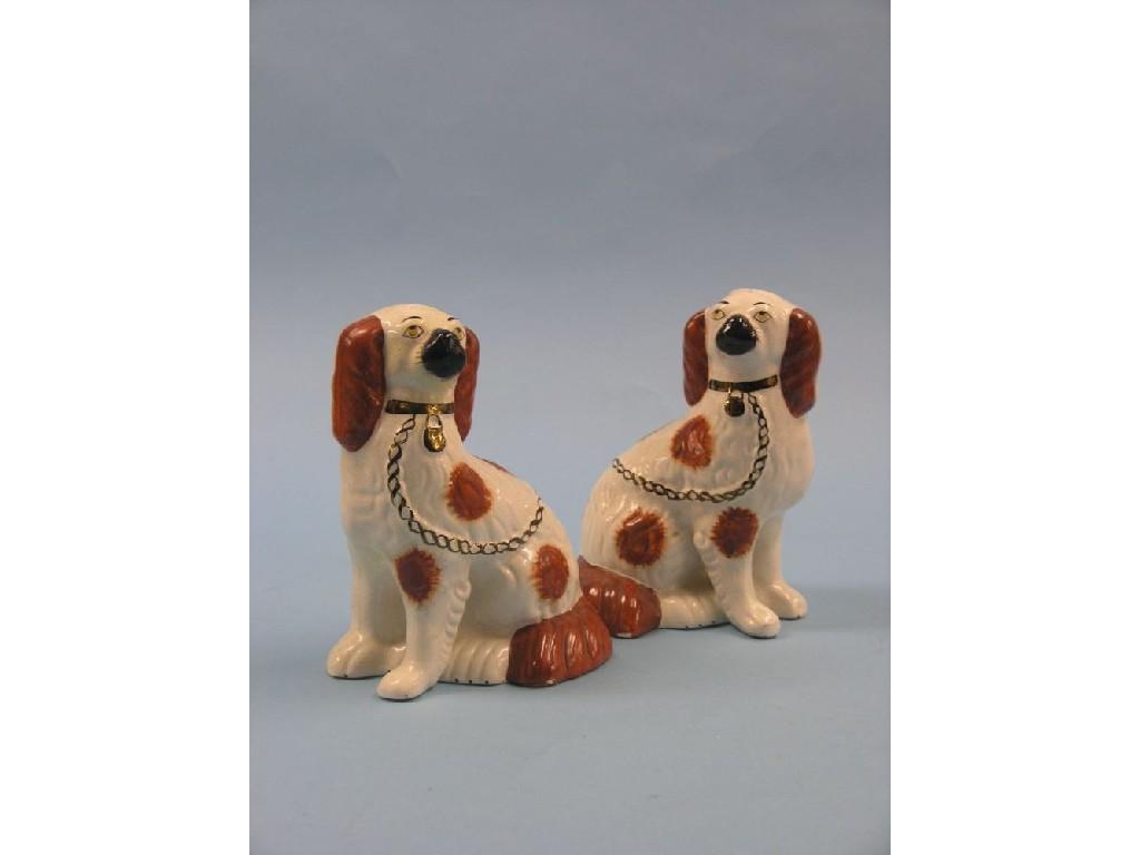 Appraisal: A pair of Victorian-style Staffordshire comforter spaniels colourings in rust