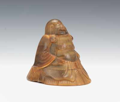 Appraisal: A Carved Horn Buddha Hotai The smiling figure seated on