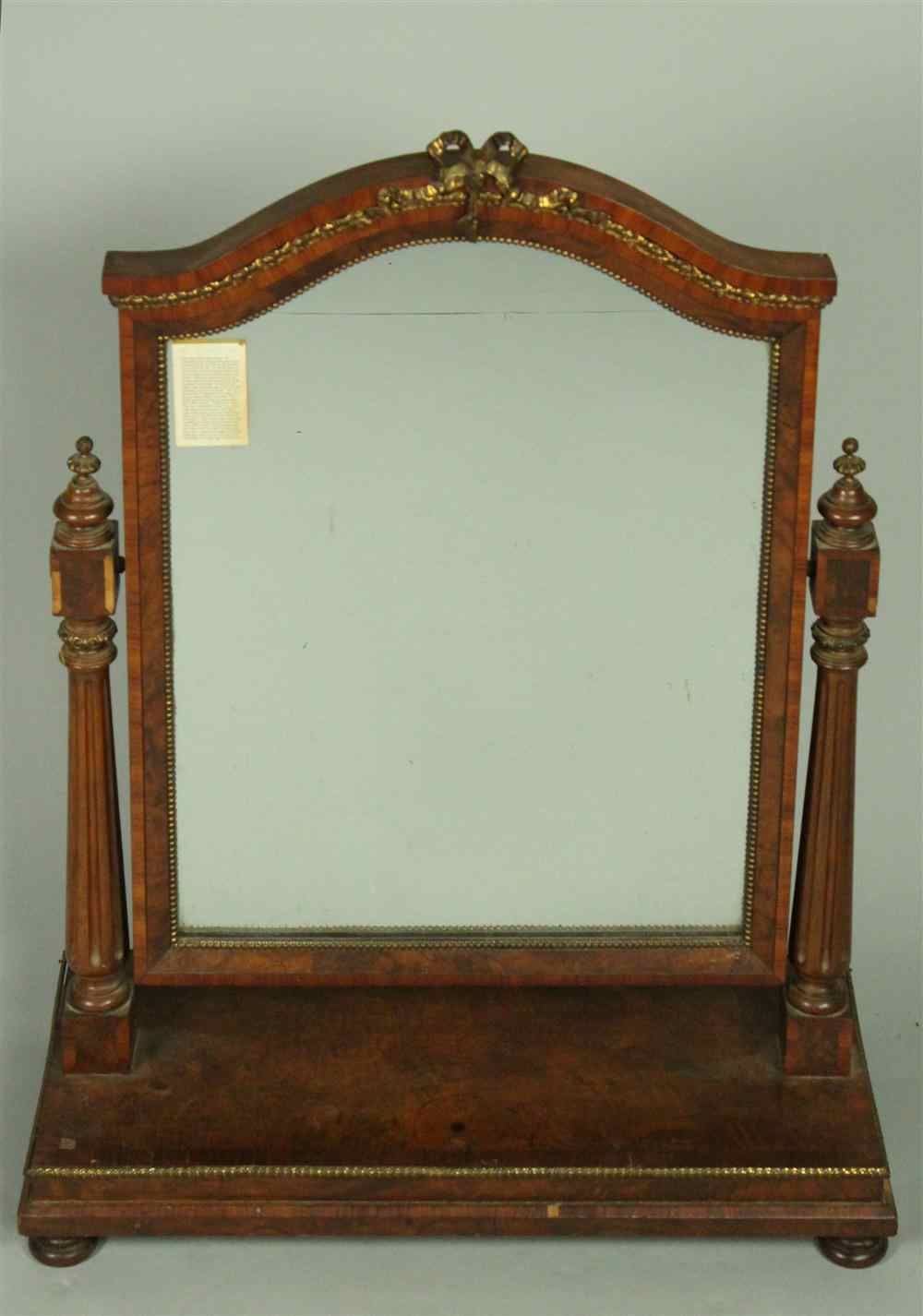 Appraisal: CLASSICAL STYLE WANUT MIRROR ON STAND the mirror having an