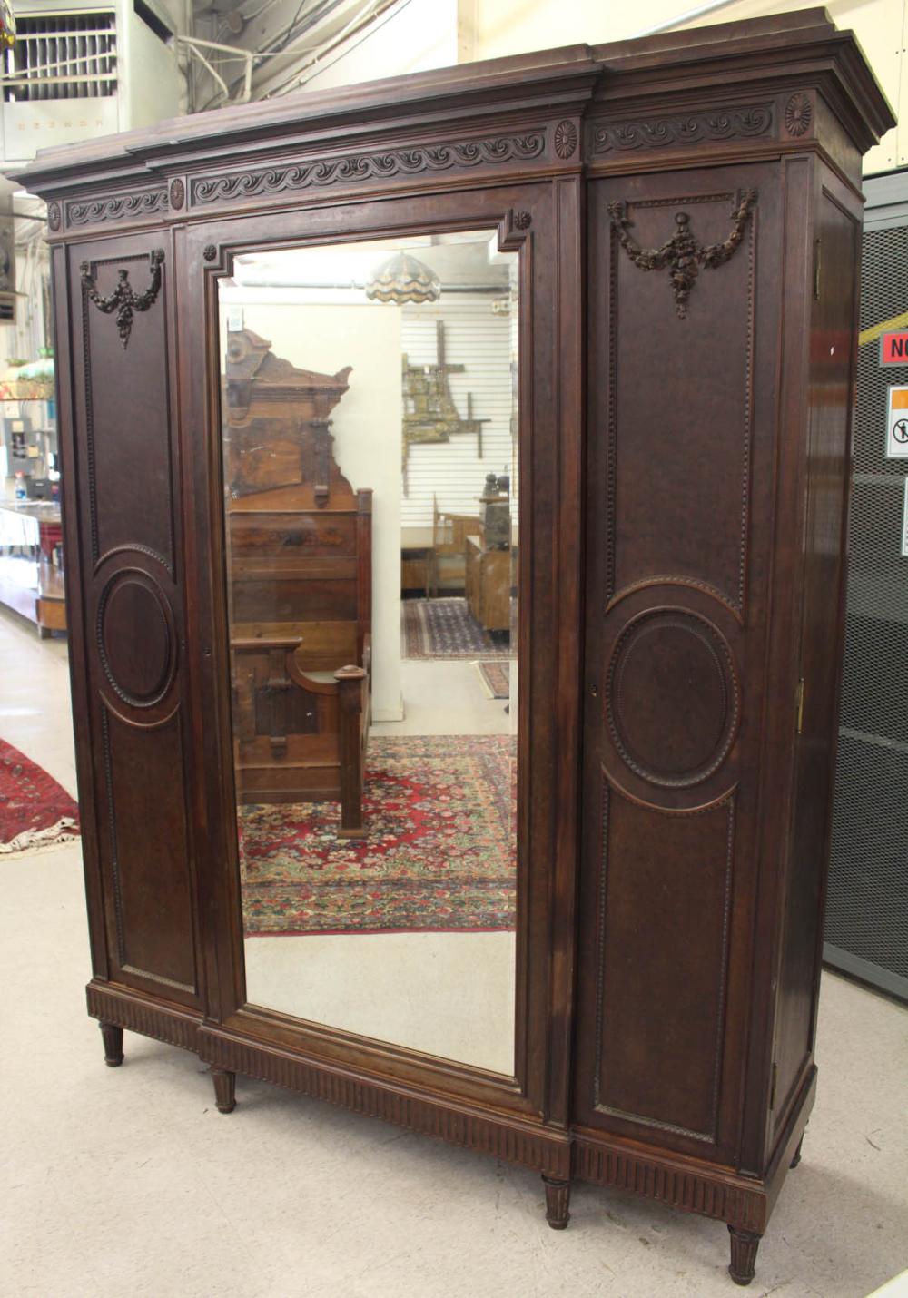 Appraisal: LOUIS XVI STYLE WALNUT THREE-DOOR ARMOIRE Continental th century H