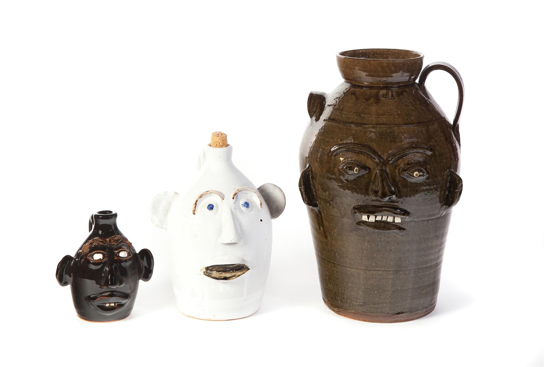 Appraisal: THREE GROTESQUE JUGS AND CROCK Late th century Crock with