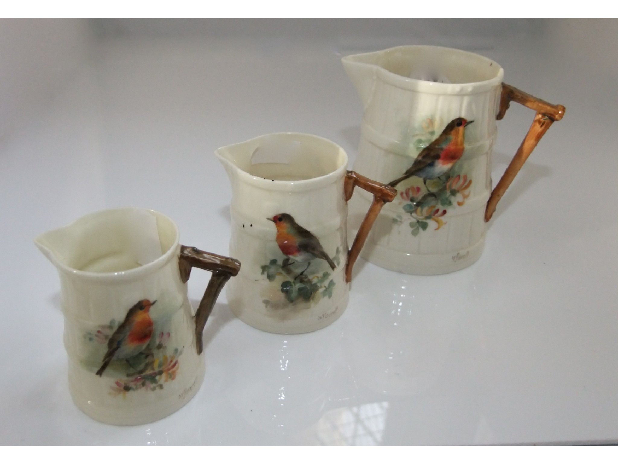 Appraisal: A set of three graduated Royal Worcester jugs with coopered