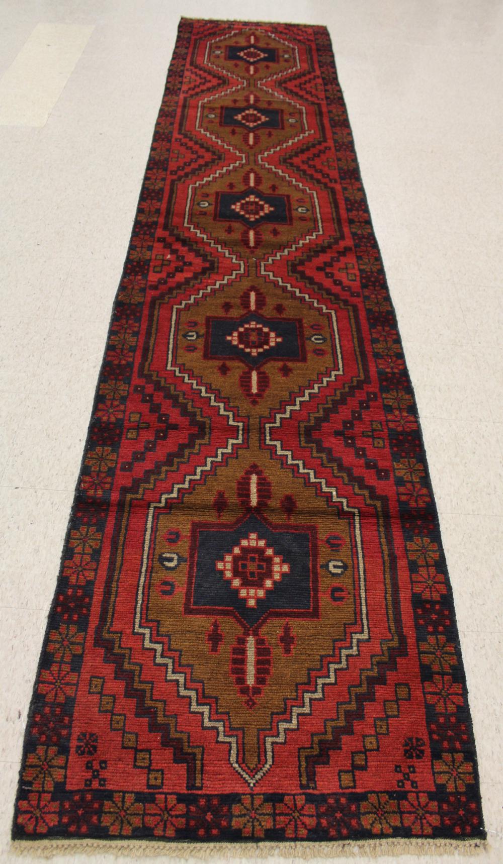 Appraisal: TWO SIMILAR HAND KNOTTED ORIENTAL RUNNERS Pakistani-Persians repeating geometric medallion