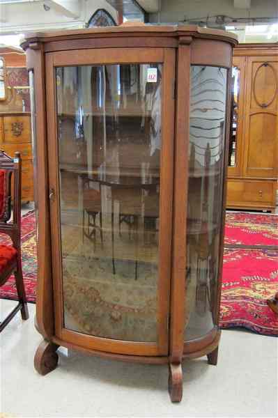 Appraisal: AN OAK AND CURVED GLASS CHINA CABINET Empire Revival design