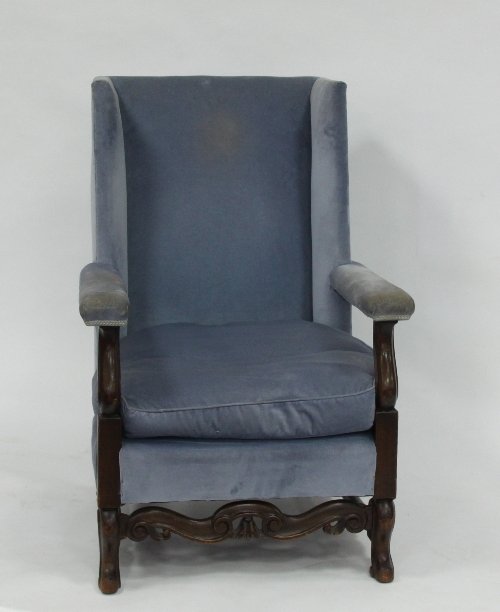 Appraisal: A William and Mary style wing back armchair the open