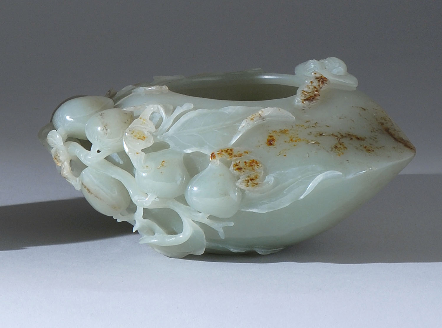 Appraisal: CELADON AND RUSSET JADE WRITER'S COUPE th th CenturyIn peach