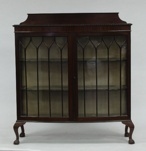 Appraisal: A mahogany bowfront display cabinet enclosed by a pair of