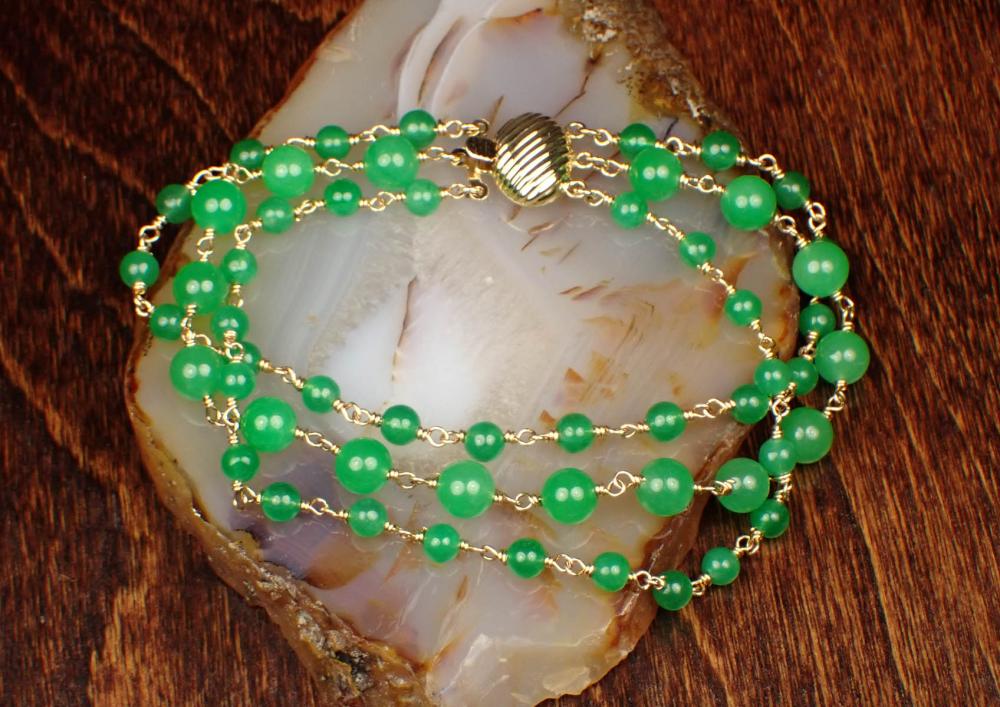 Appraisal: JADE AND FOURTEEN KARAT GOLD TRIPLE STRAND BRACELET with two