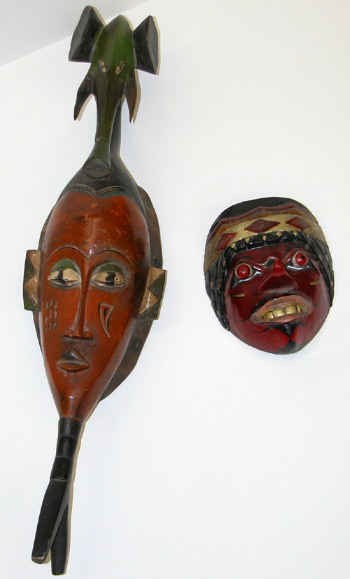 Appraisal: Two Masks th Century Mask School Wood Carving painted in