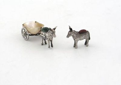 Appraisal: A small donkey pin cushion pulling a mother of pearl