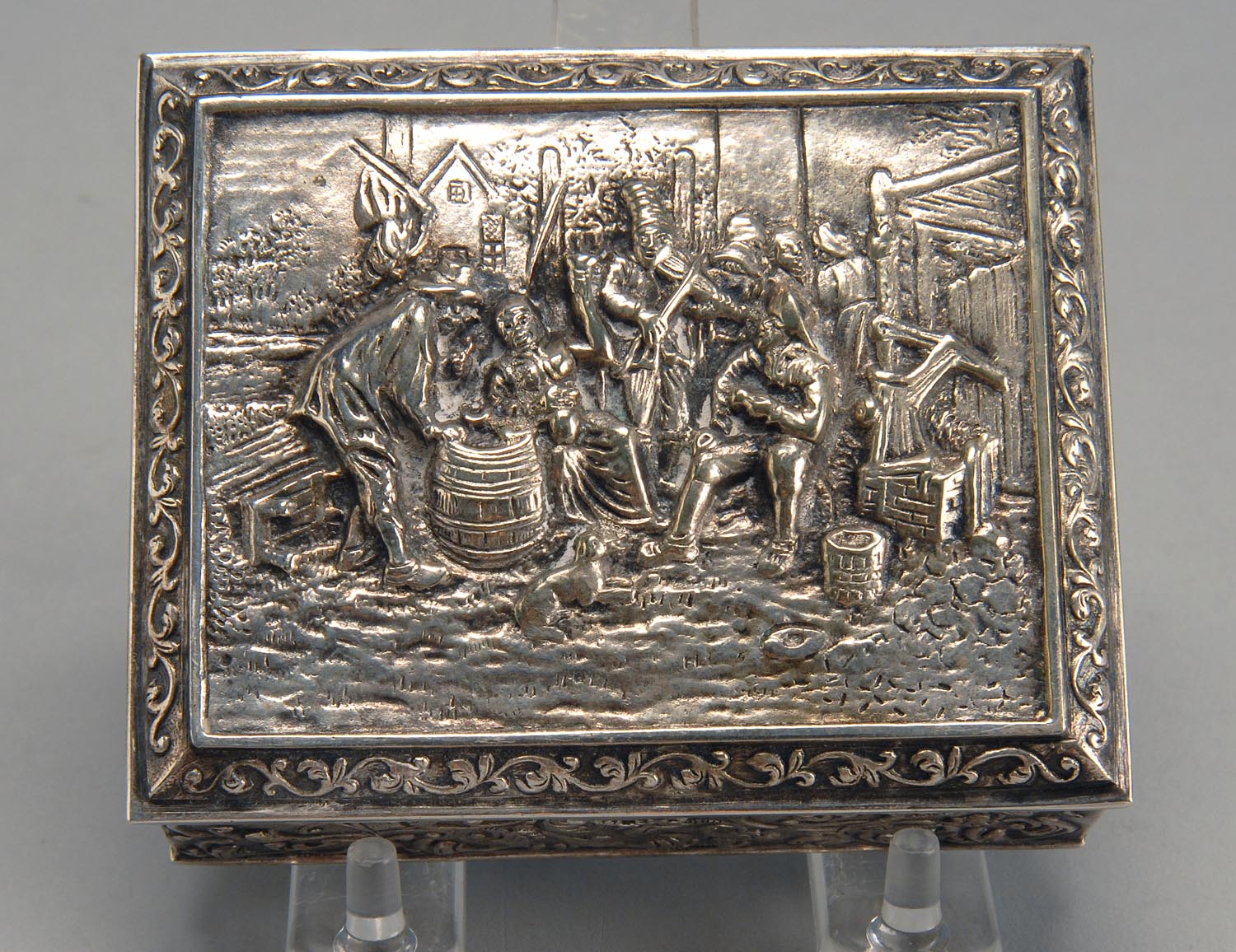 Appraisal: CONTINENTAL SILVER BOX With repouss scene of figures dancing outside