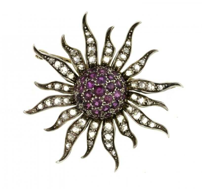 Appraisal: A RUBY AND DIAMOND SUN IN SPLENDOUR BROOCH with central