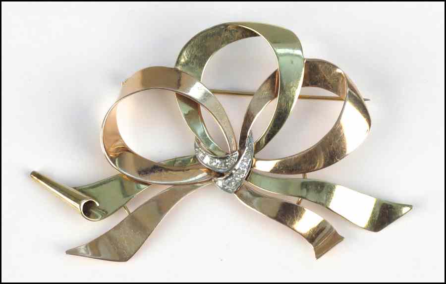 Appraisal: KARAT YELLOW AND ROSE GOLD AND DIAMOND BOW KNOT BROOCH