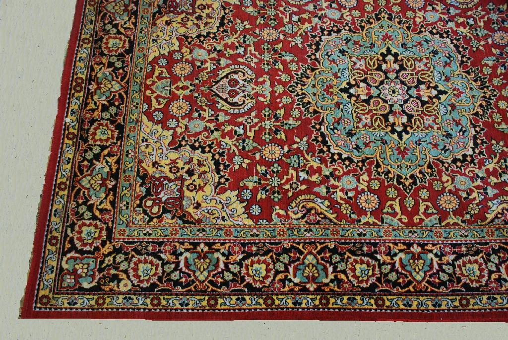 Appraisal: PERSIAN CARPET with a turquoise and black central medallion with