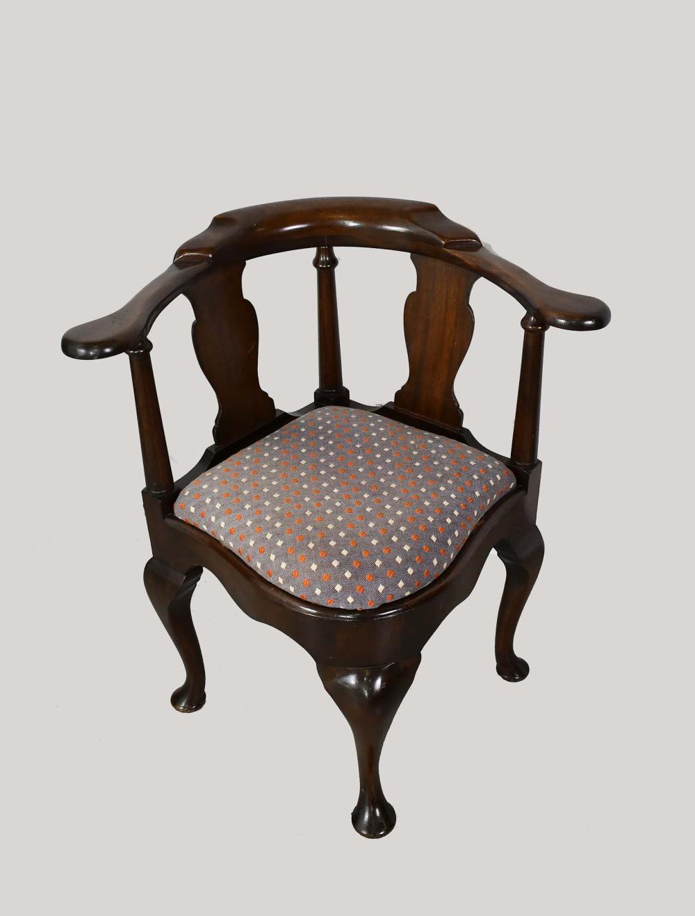 Appraisal: GEORGE III STYLE MAHOGANY CORNER ARMCHAIRThe curved back above solid