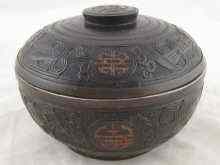 Appraisal: A Chinese turned lined hardwood covered bowl with incised decoration