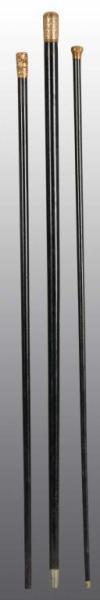 Appraisal: Lot of Black Canes with Gold Tops Description One cane