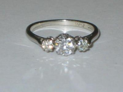 Appraisal: A THREE STONE DIAMOND RING with larger brilliant cut central