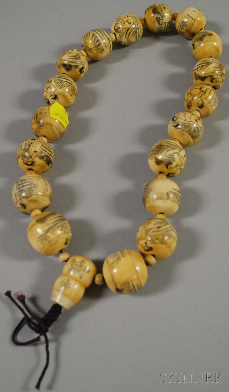 Appraisal: Japanese Erotic Etched Ivory Beads approx lg bead dia in