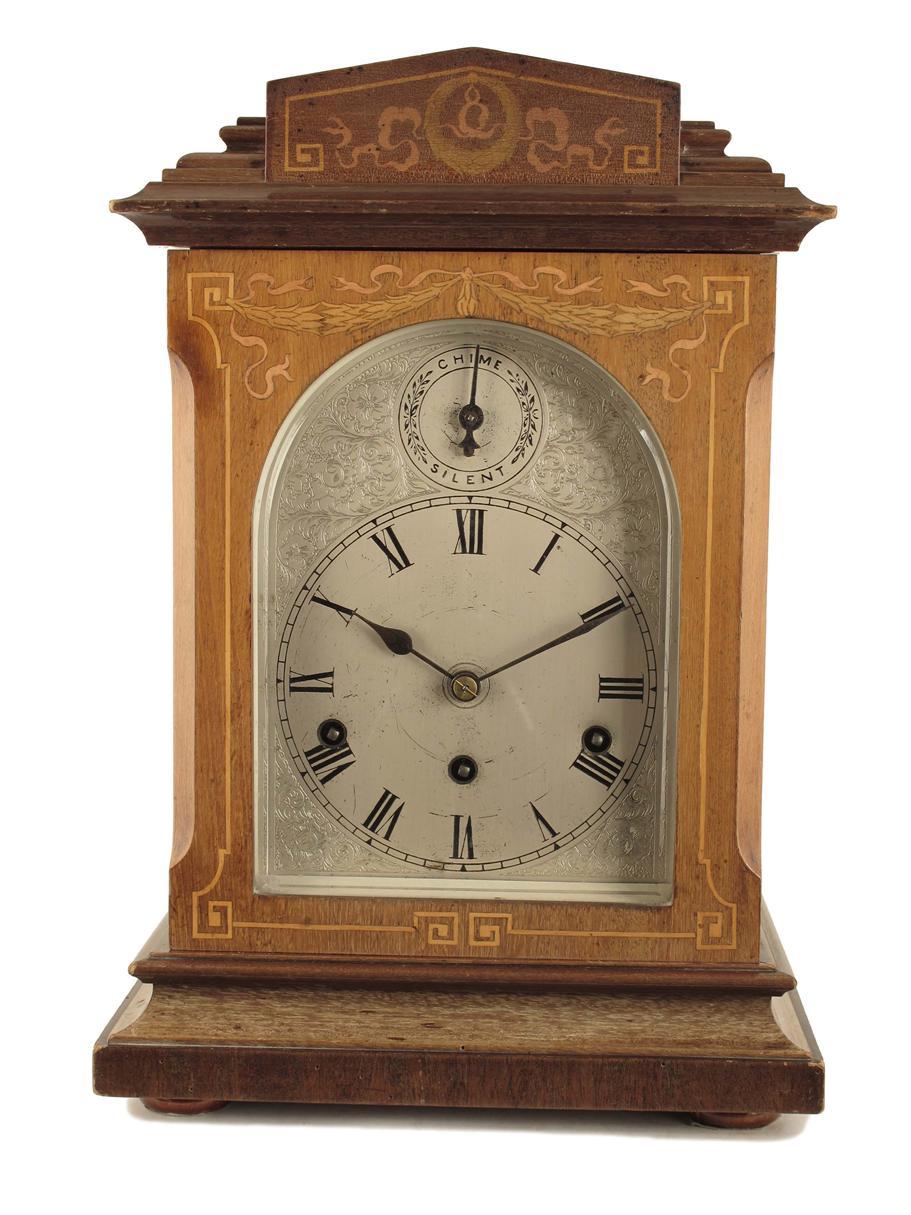 Appraisal: A mahogany and marquetry chiming mantel clock