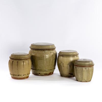 Appraisal: Mike Dodd British born four celadon glazed storage jars and