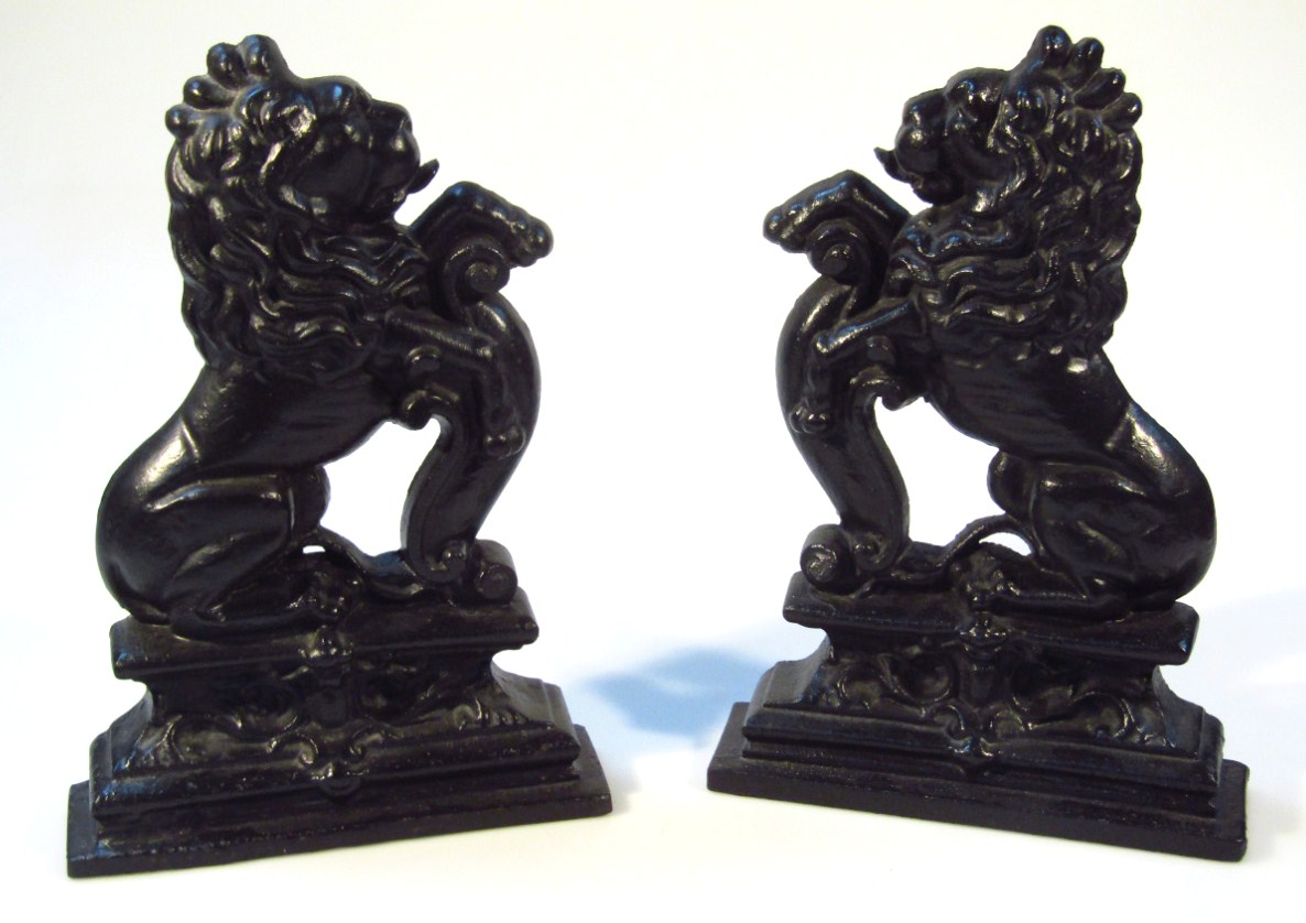 Appraisal: A pair of thC cast iron lion doorstops each in