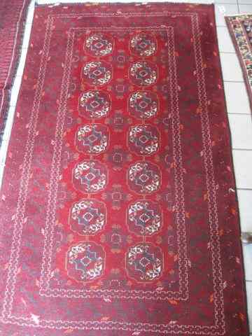 Appraisal: Turkman Handmade Rug indigo ivory on deep red field tight