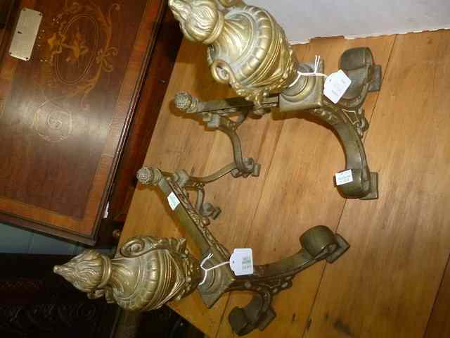 Appraisal: A PAIR OF LATE VICTORIAN CAST BRASS FIRE DOGS the