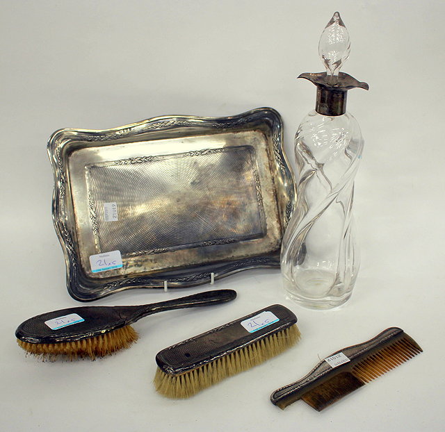 Appraisal: A SILVER MOUNTED DECANTER together with a silver rectangular dressing